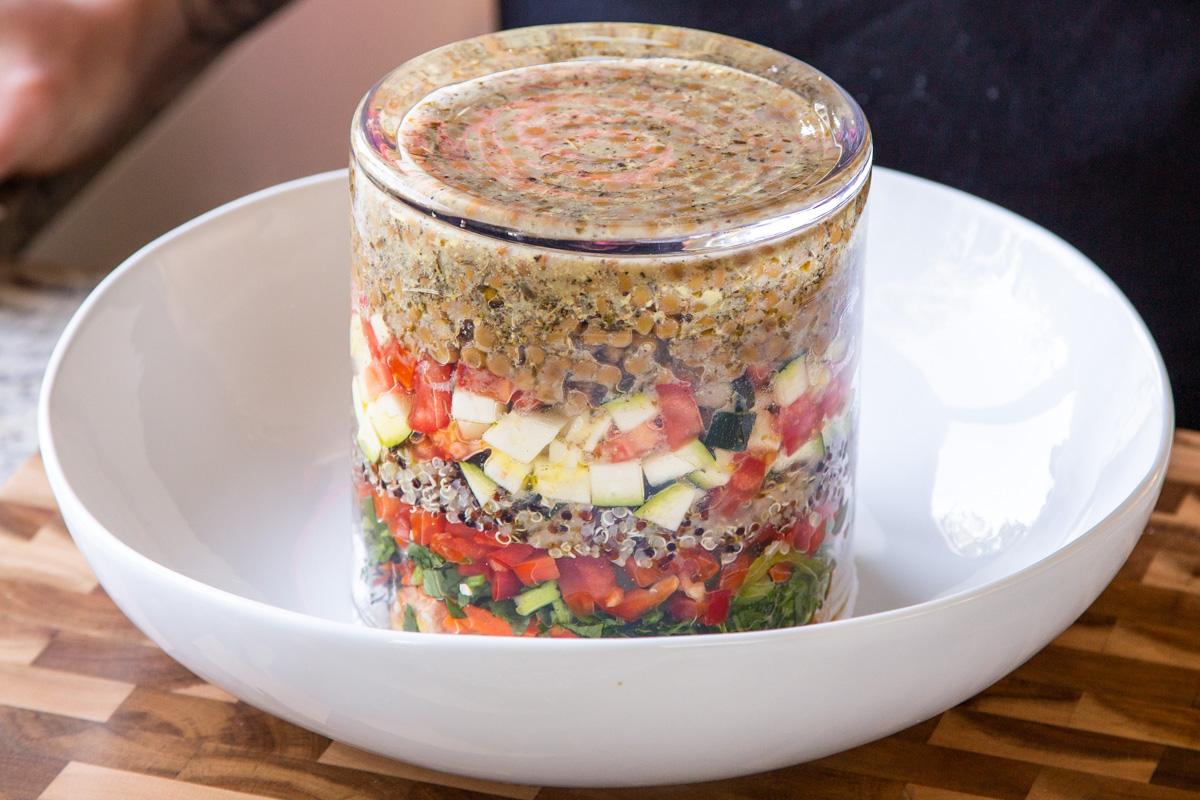 inverting the jar salad into a mixing bowl