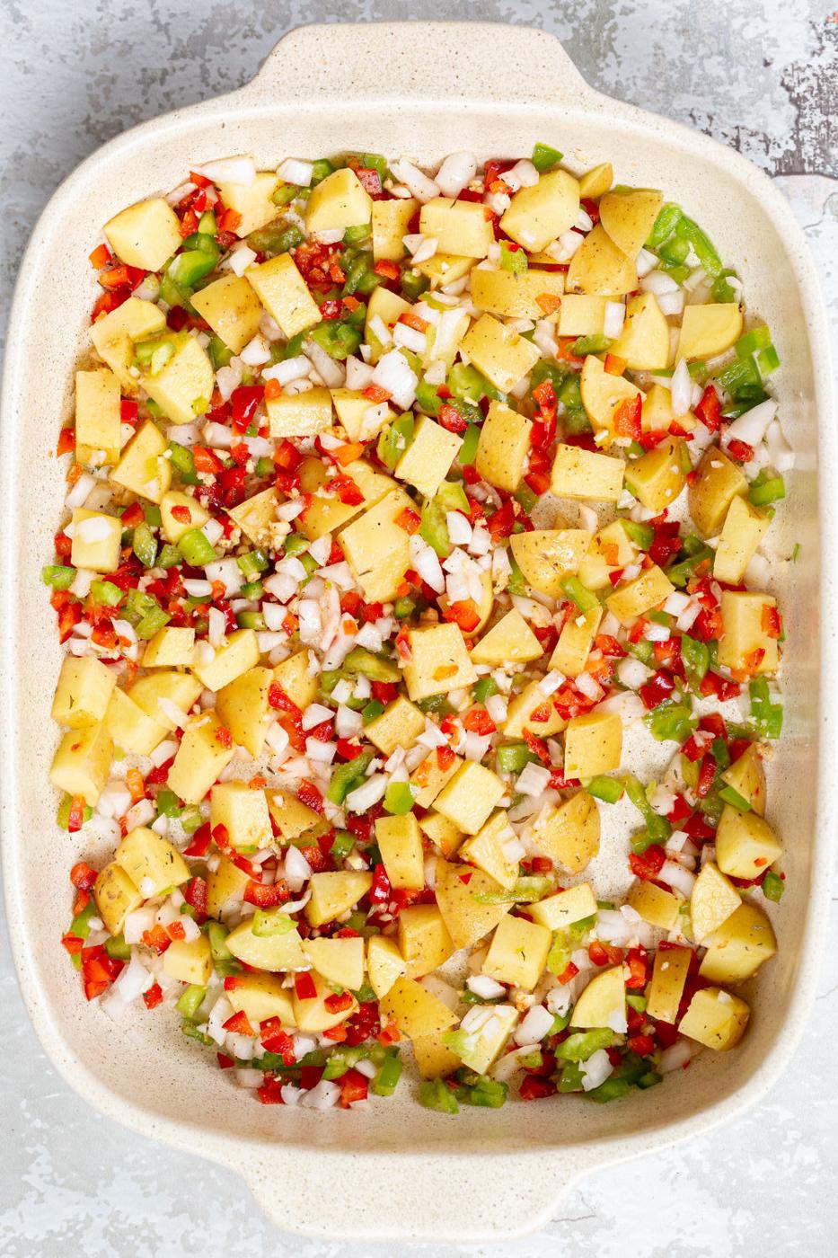 overhead shot of a Breakfast Potatoes in a white baking dish ready to be baked