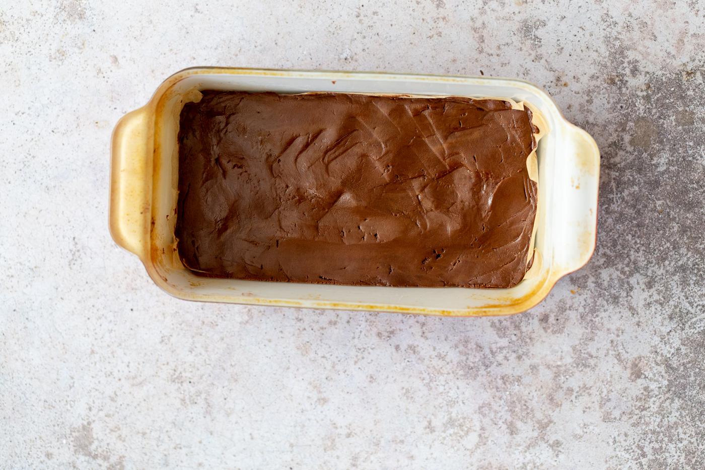 vegan chocolate fudge in a white loaf pan ready to be chilled