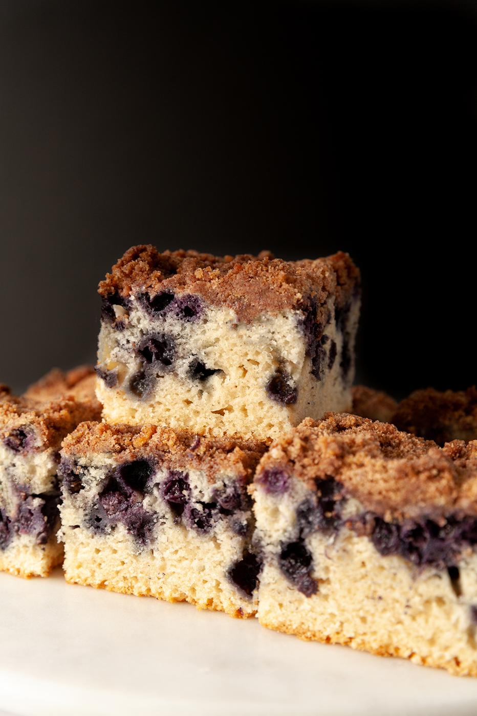 eggless lemon blueberry sheet cake against a black background