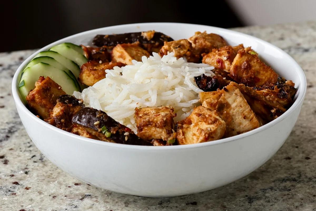 eggplant and tofu in the bowl with rice before adding toppings