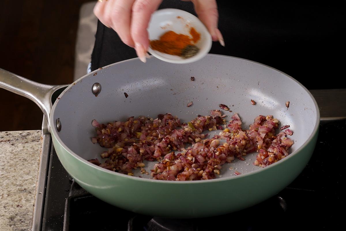 adding ground spices to the pan