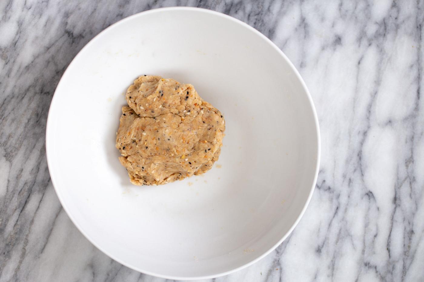 vegan everyrhing bagel cracker dough in a small white bowl