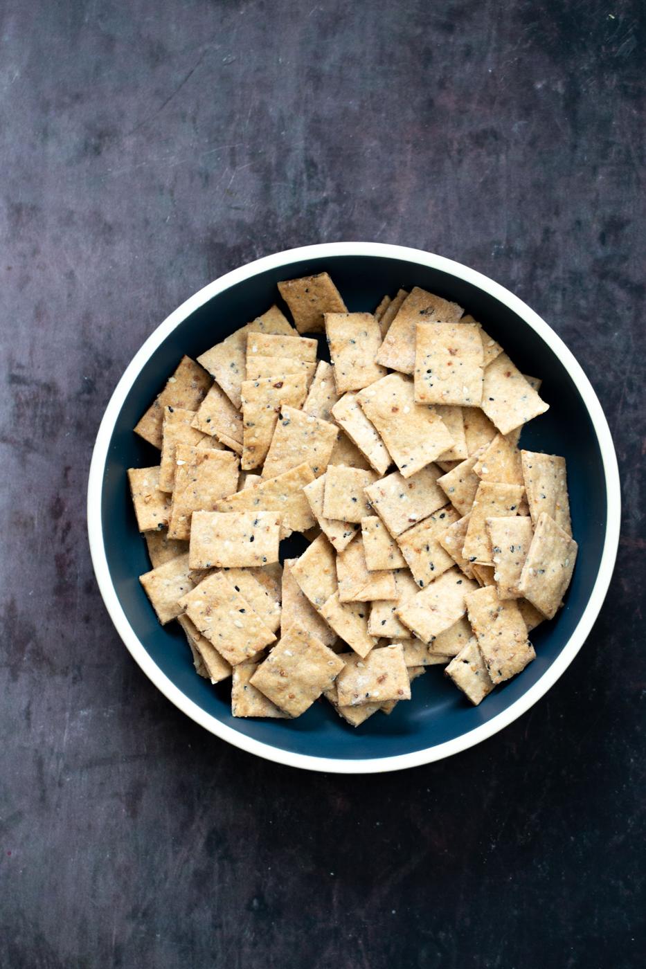 overhead shot of a bowl with vegan Everything Bagel Crackers