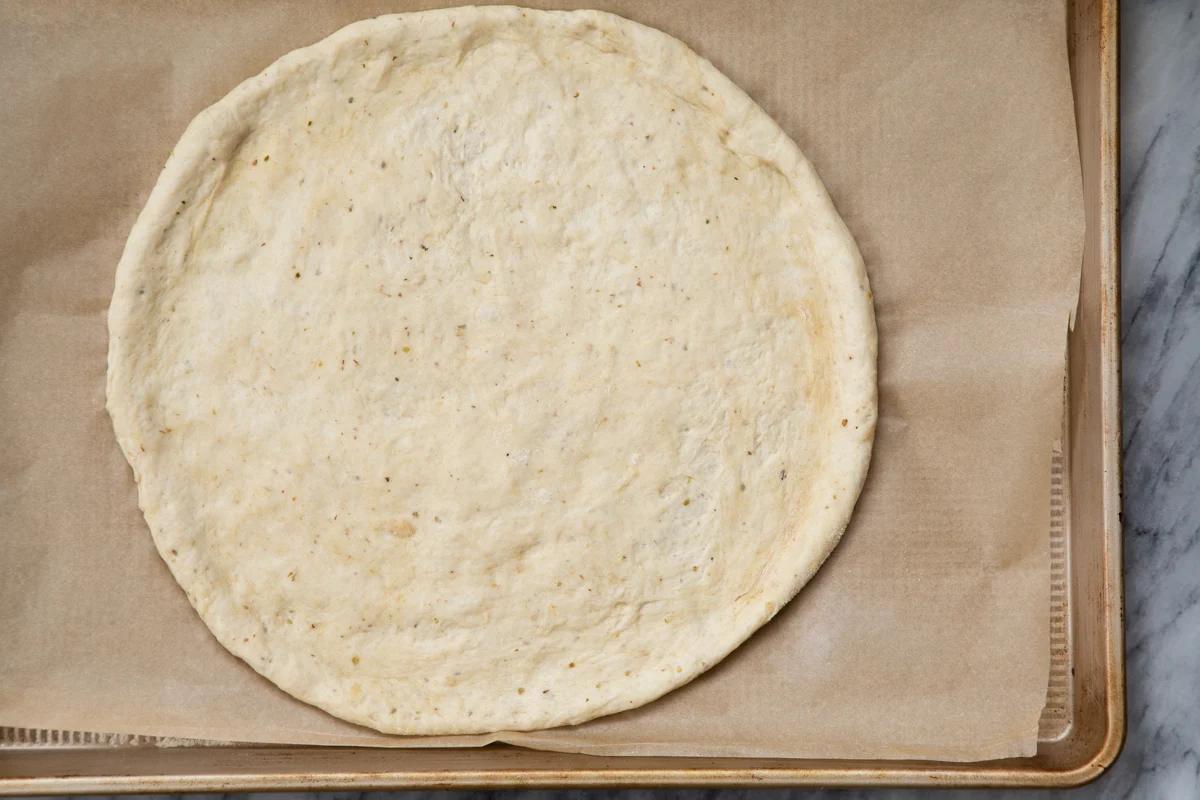 vegan pizza dough on a baking sheet