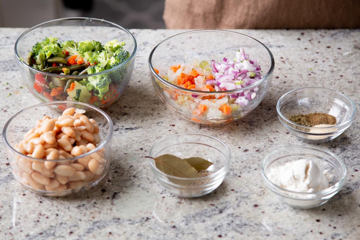 veggies, beans, and seasonings in bowls on the kitchen counter