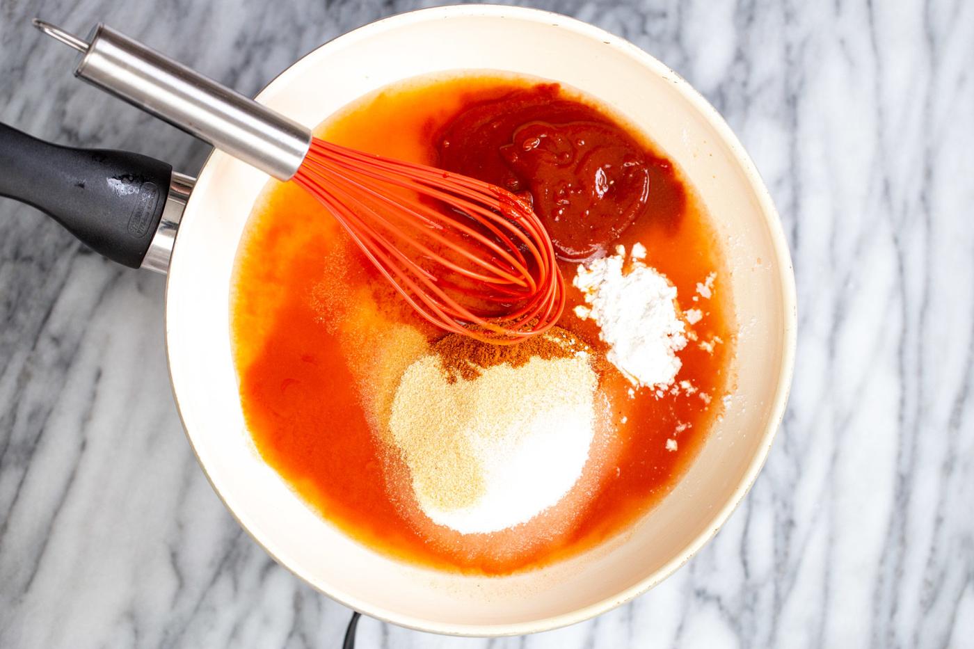 firecracker sauce ingredients being stirred together in a small saucepan