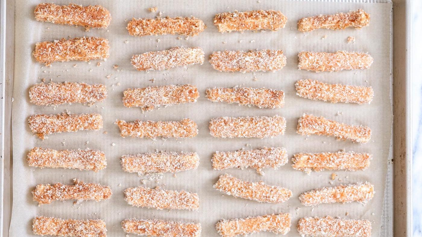 breaded vegan tofu wings on.a parchment paper lined baking sheet