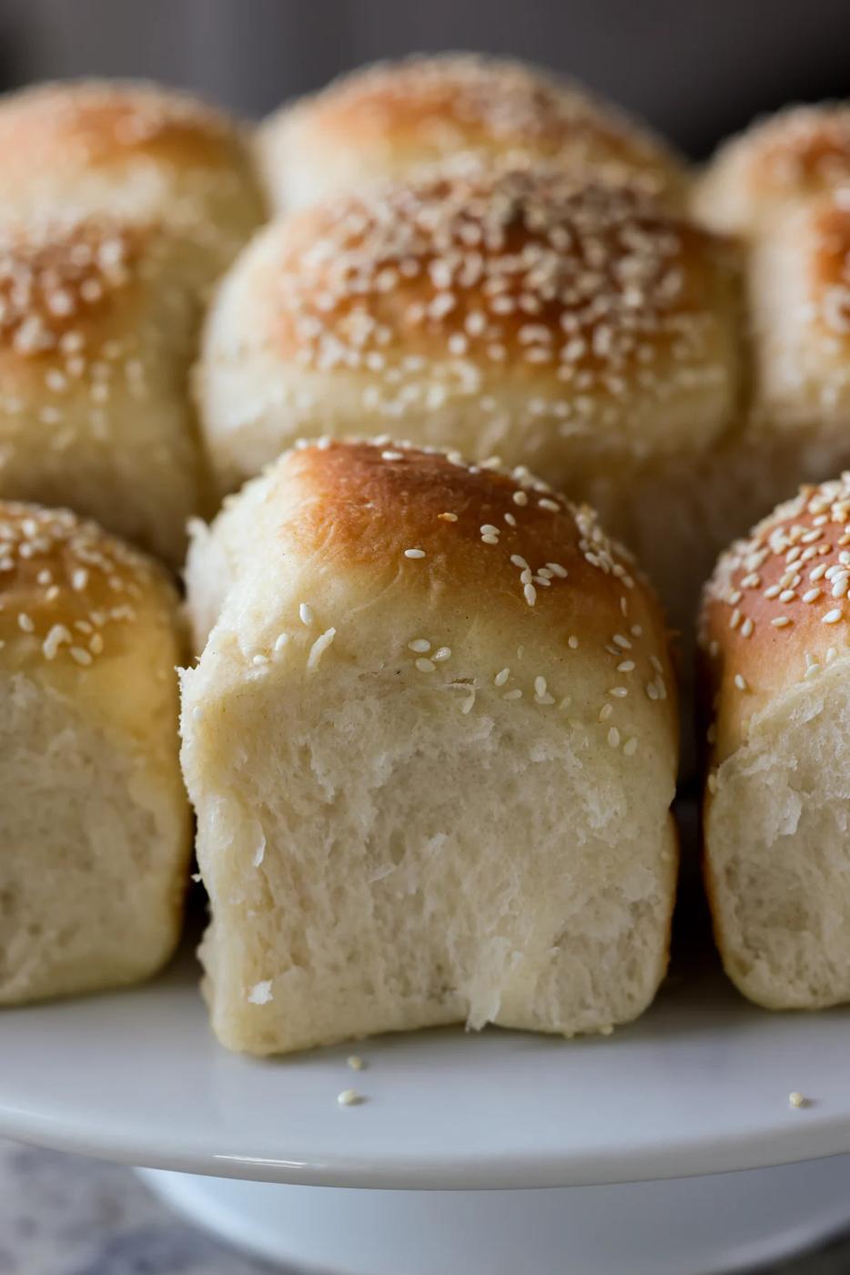 fluffy dinner rolls on a serving tray after pulling apart