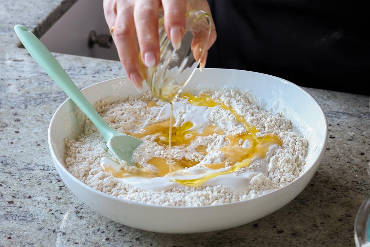 adding melted vegan butter and oil to the dough