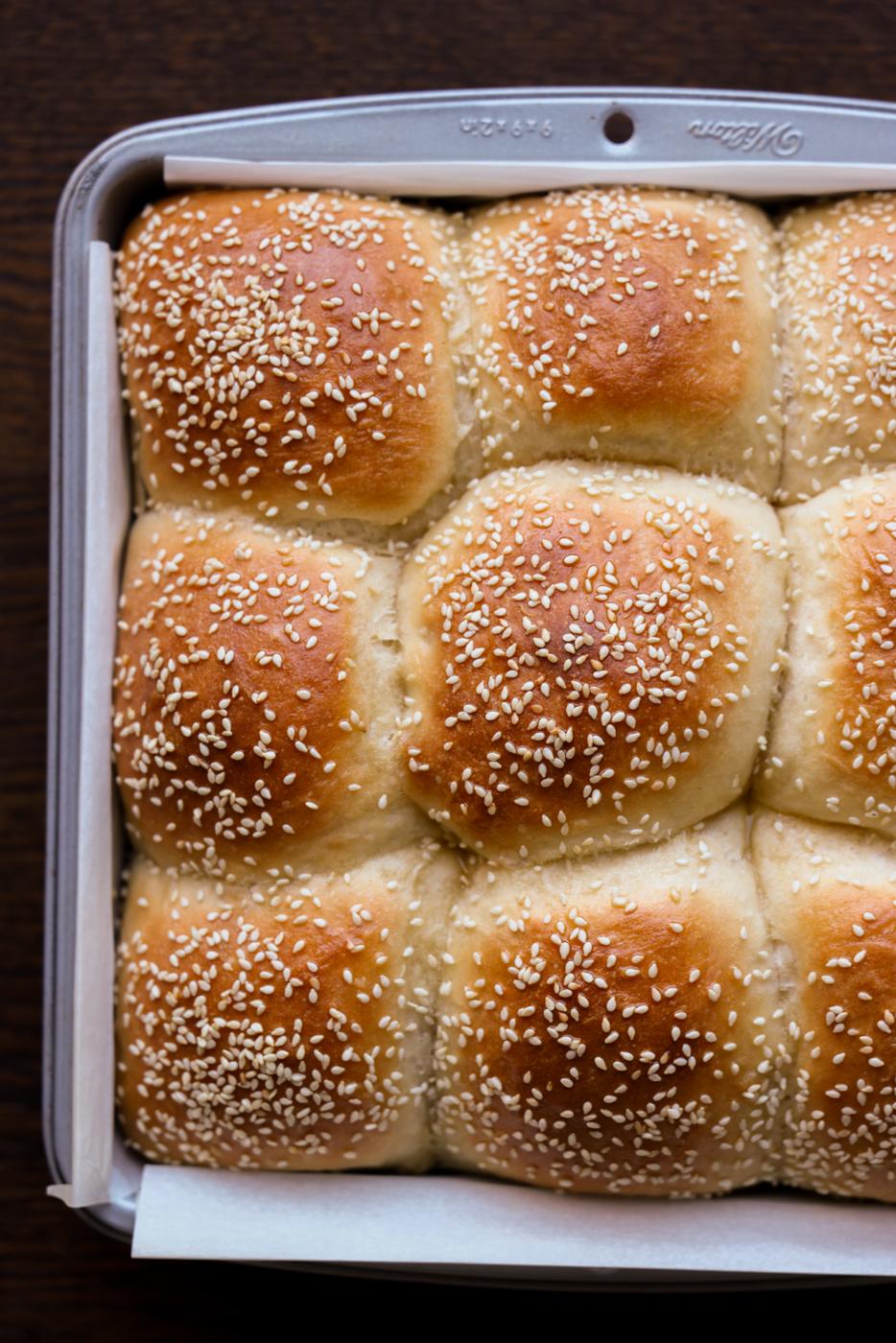 overhead photo of fluffy dinner rolls in the baking pan