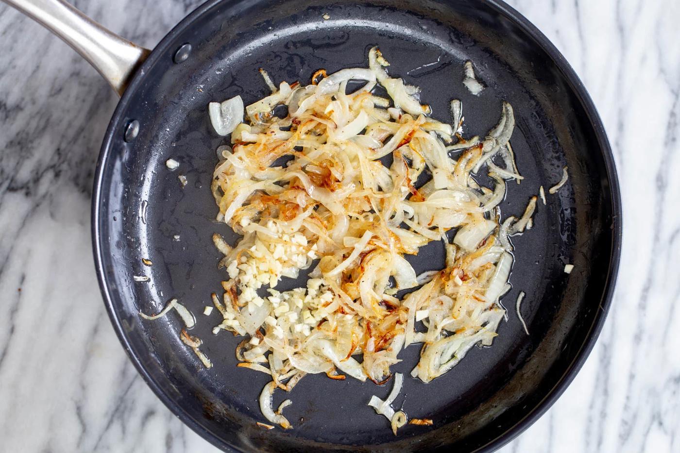 slightly golden sauteed onion sliced in a skillet