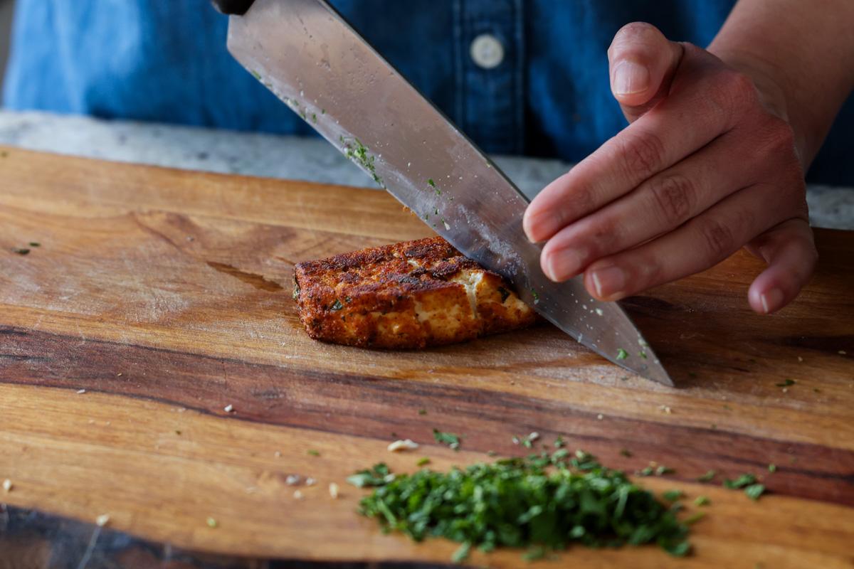 cutting crispy tofu on the cutting board