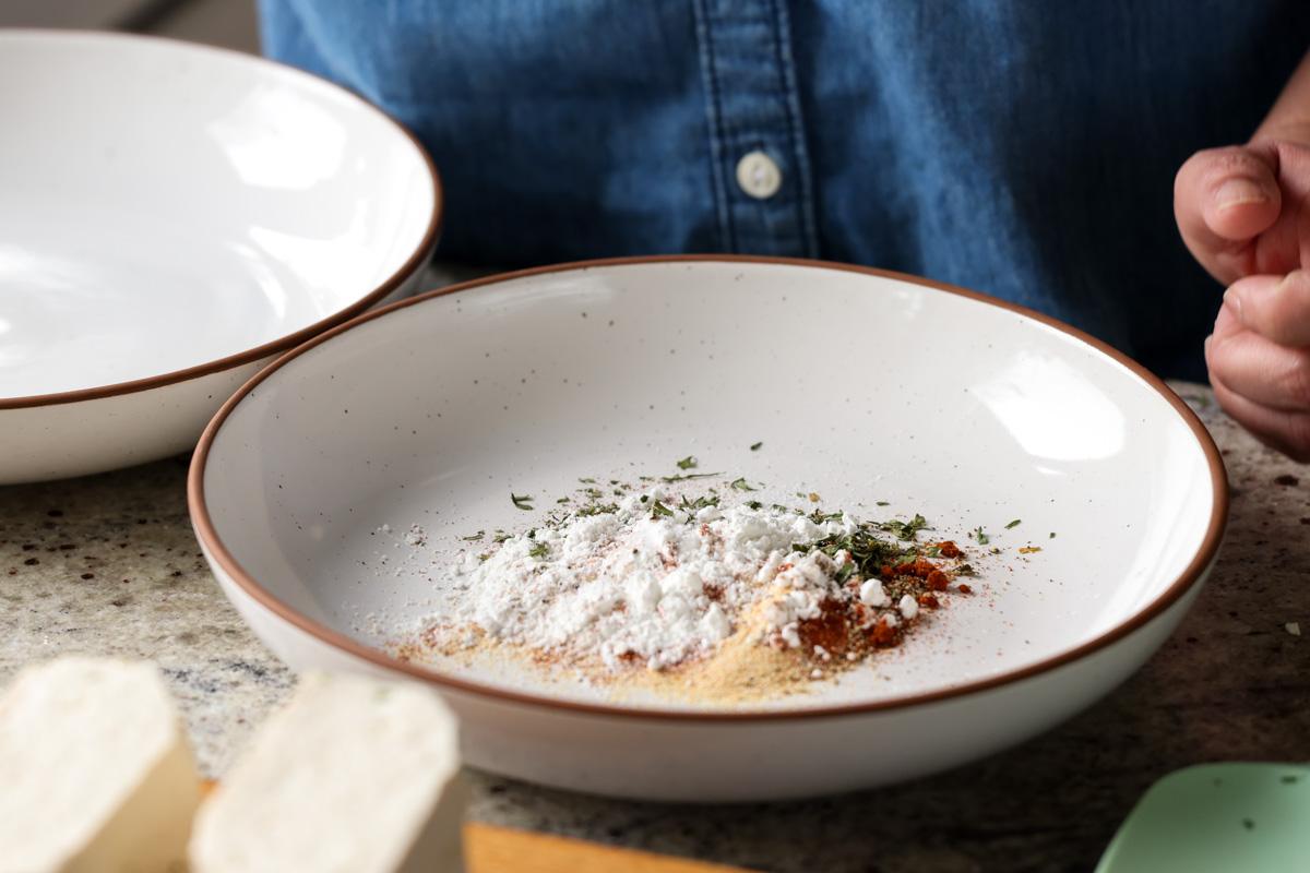 adding cornstarch and spices to the bowl