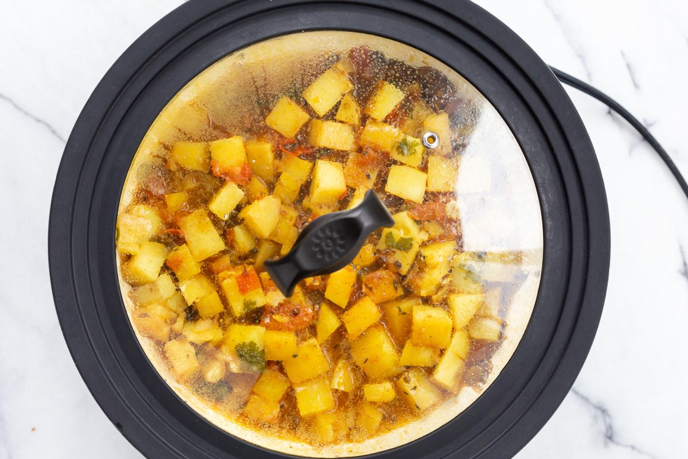 Potatoes and tomatoes in white skillet