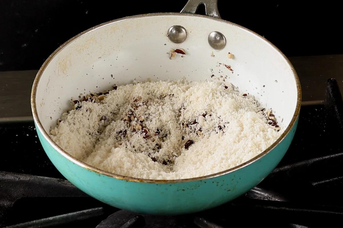 adding coconut to the pecans