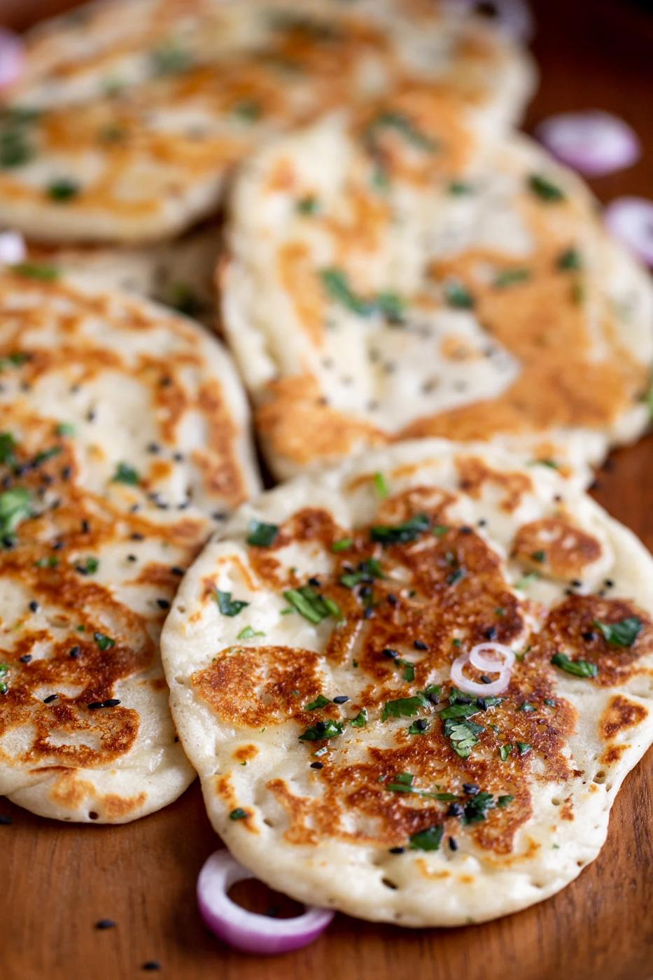 buttered almond flour naan on a chopping board