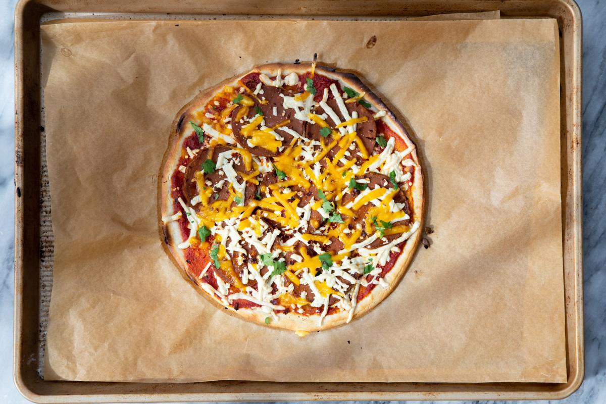 freshly baked vegan almond flour pizza with cheese and pepperoni