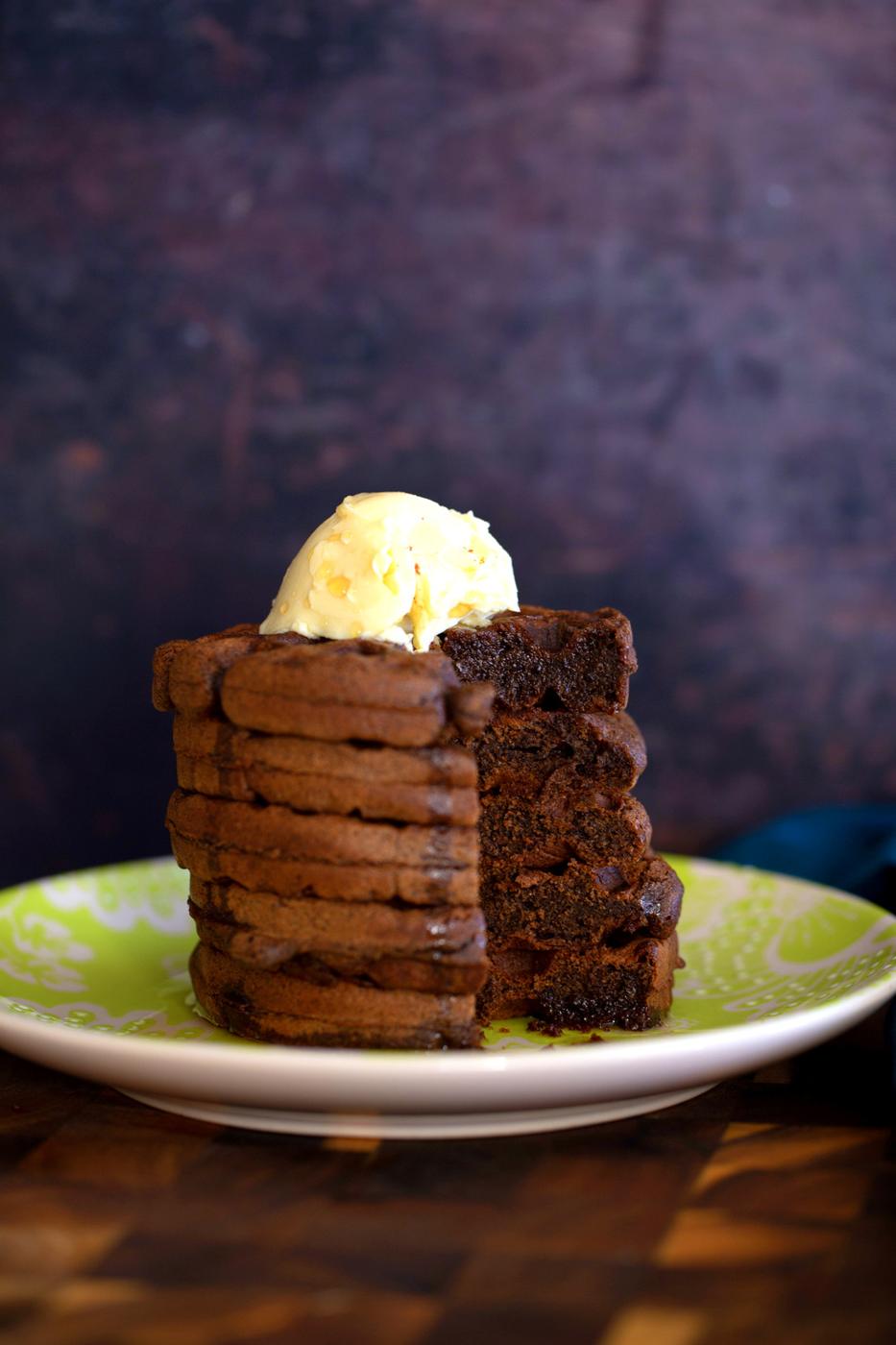 a stack of glutenfree chocolate buckwheat waffles topped with vanilla ice cream