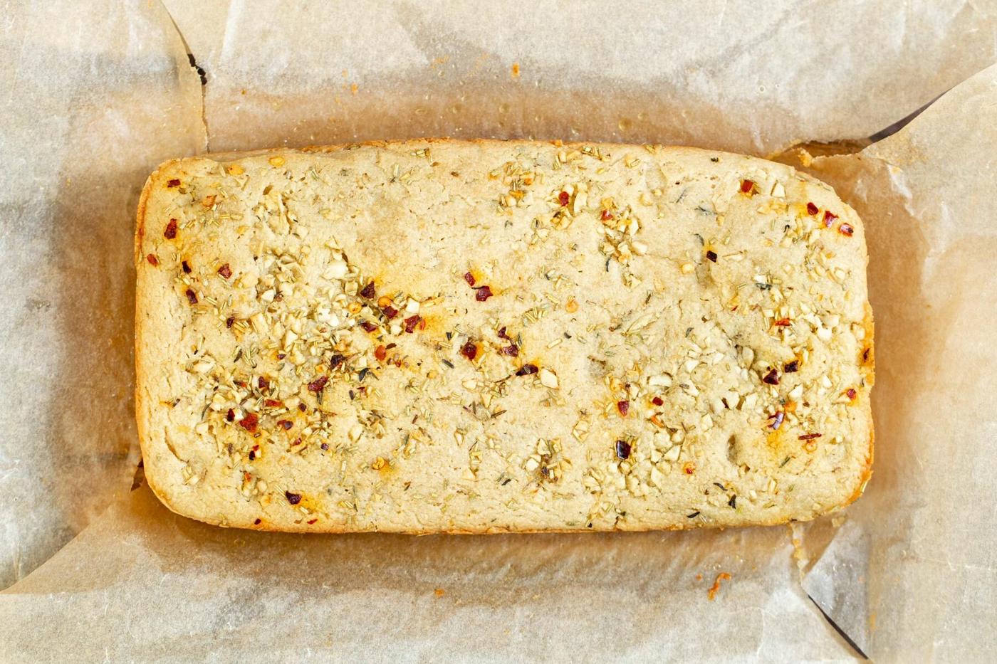 a loaf of glutenfree focaccia on parchment paper