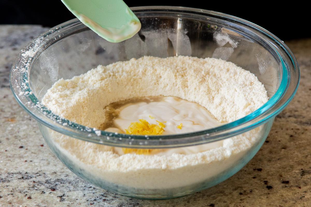 adding lemon zest and juice to the dry ingredients