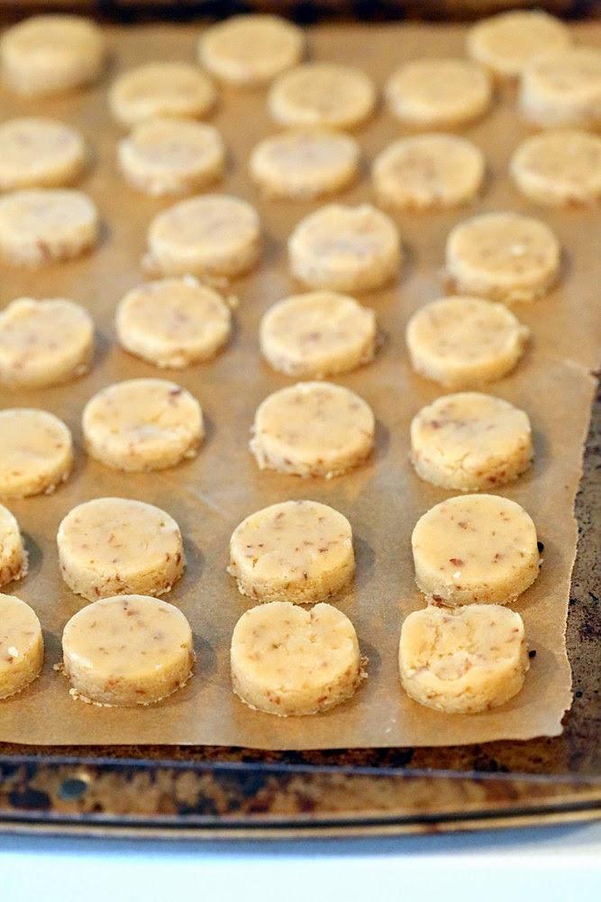 gluten-free vegan sugar cookies lined up on a baking sheet ready to be baked