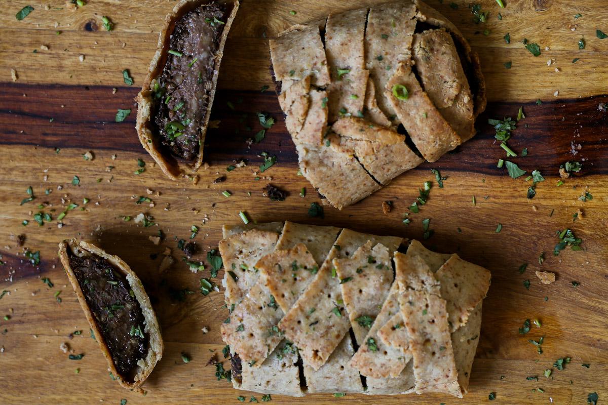 gluten-free vegan beef Wellington on a cutting board after baking and slicing