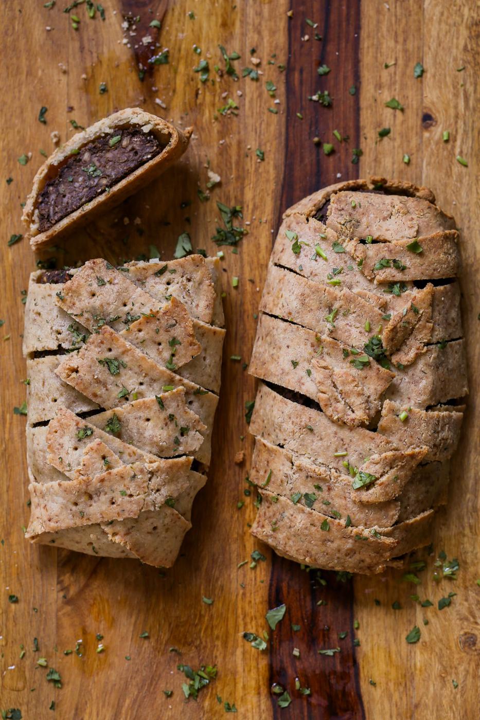 gluten-free vegan beef Wellington on a cutting board after baking and slicing