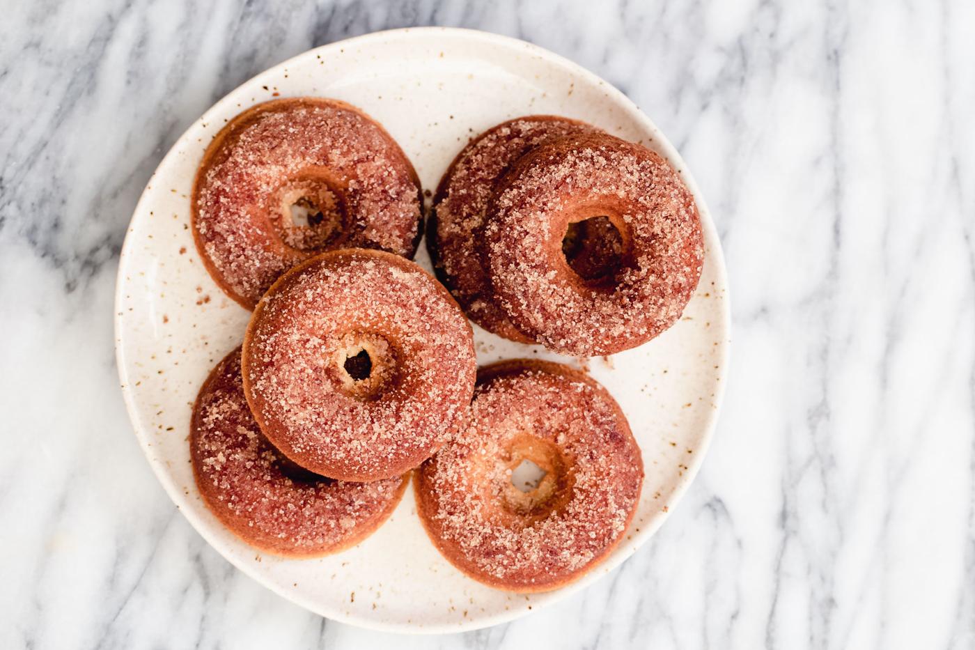 freshly baked glutenfree vanilla donuts on a white plate