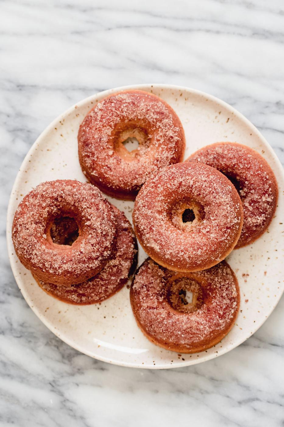 a plate with glutenfree donuts coated in cinnamon sugar