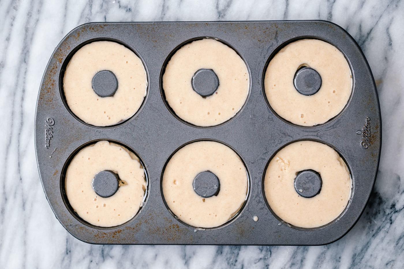 glutenfree almond flour donuts batter being filled into donuts pan