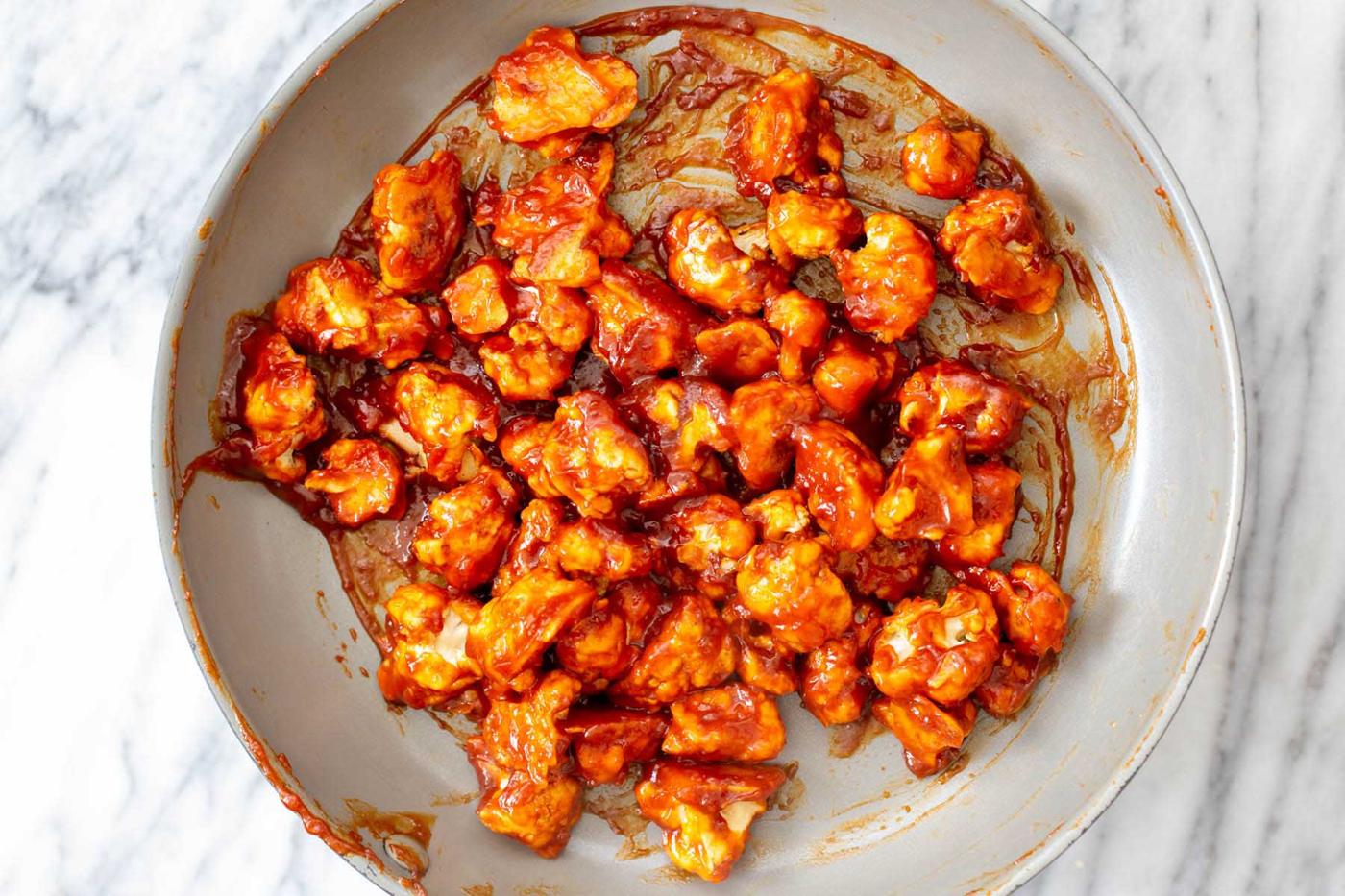 cauliflower tossed in gochujang sauce in the pan