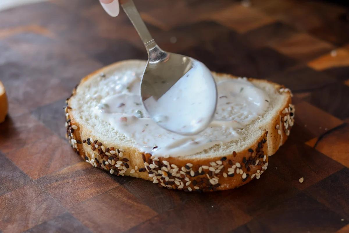 spreading mayo on the bread