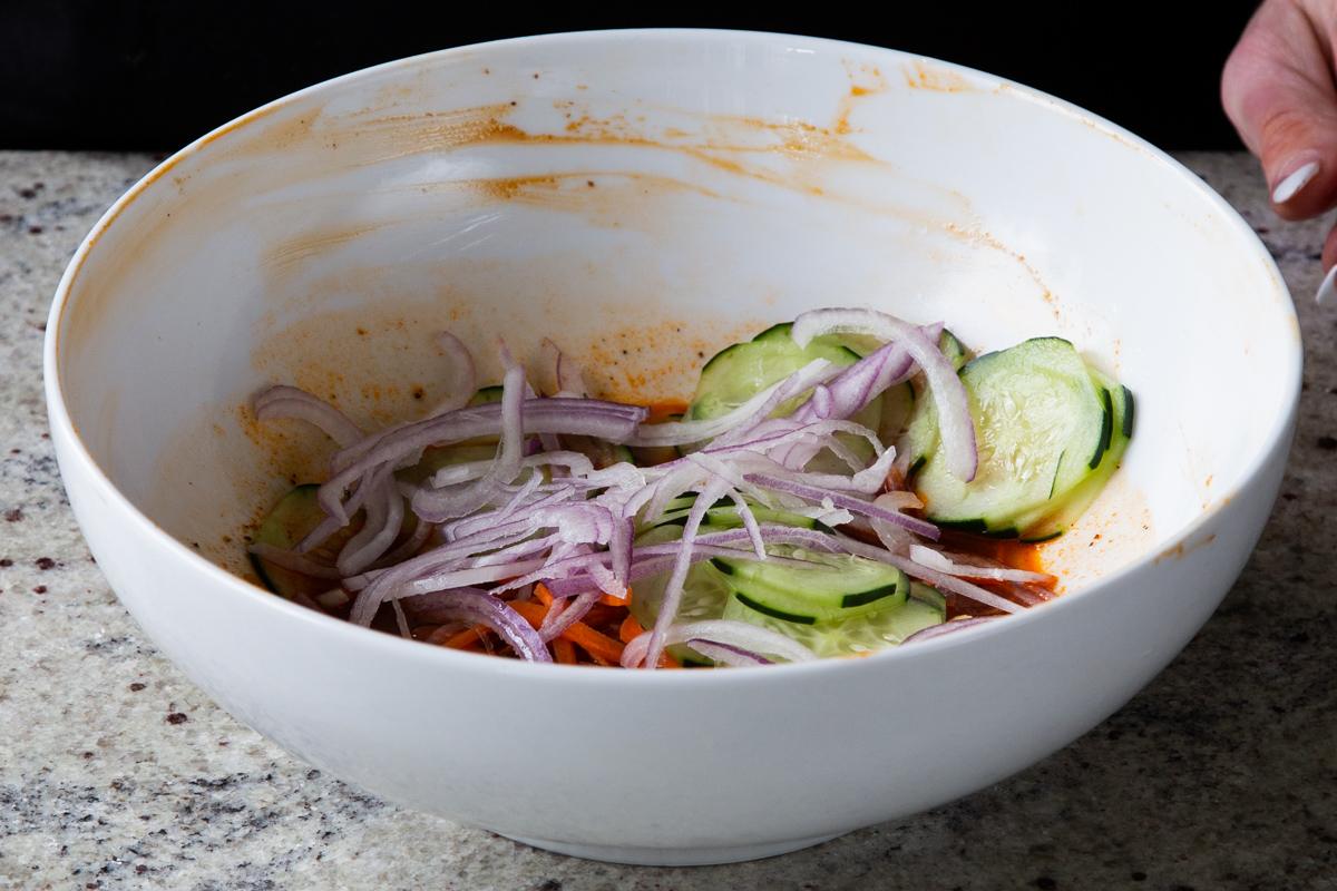 onions added with cucumbers and carrots to the marinade, before mixing