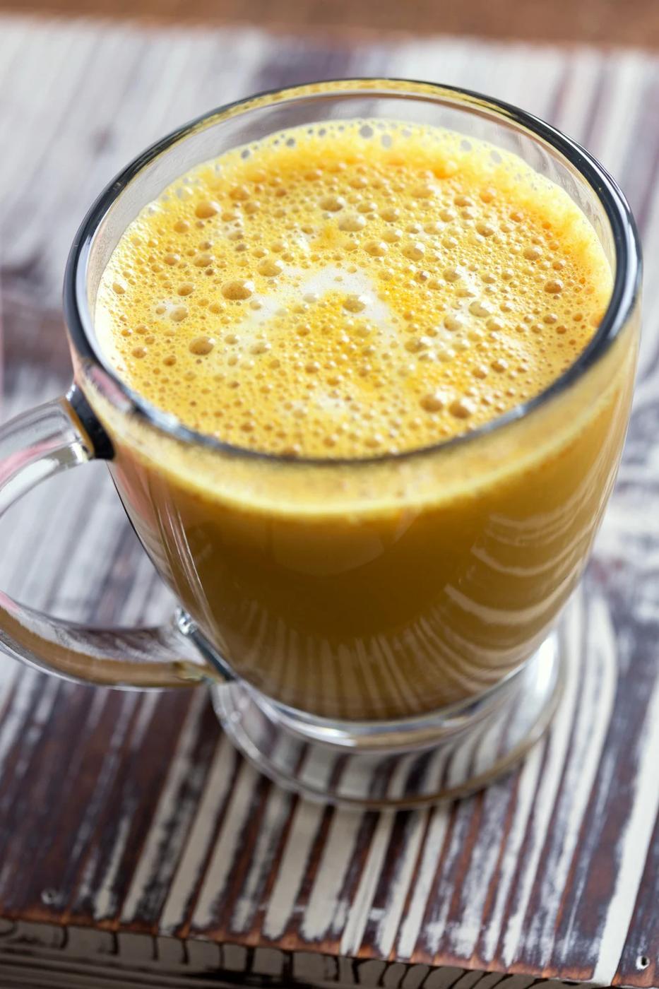 Golden Chai Latte made with our golden chai mix and almond milk in a glass cup