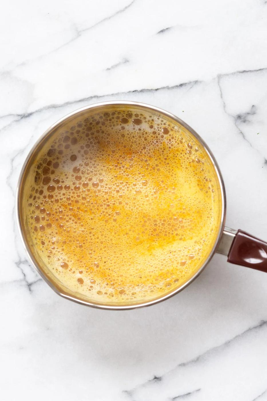Turmeric Chai latte in a saucepan made with our Golden Chai Mix