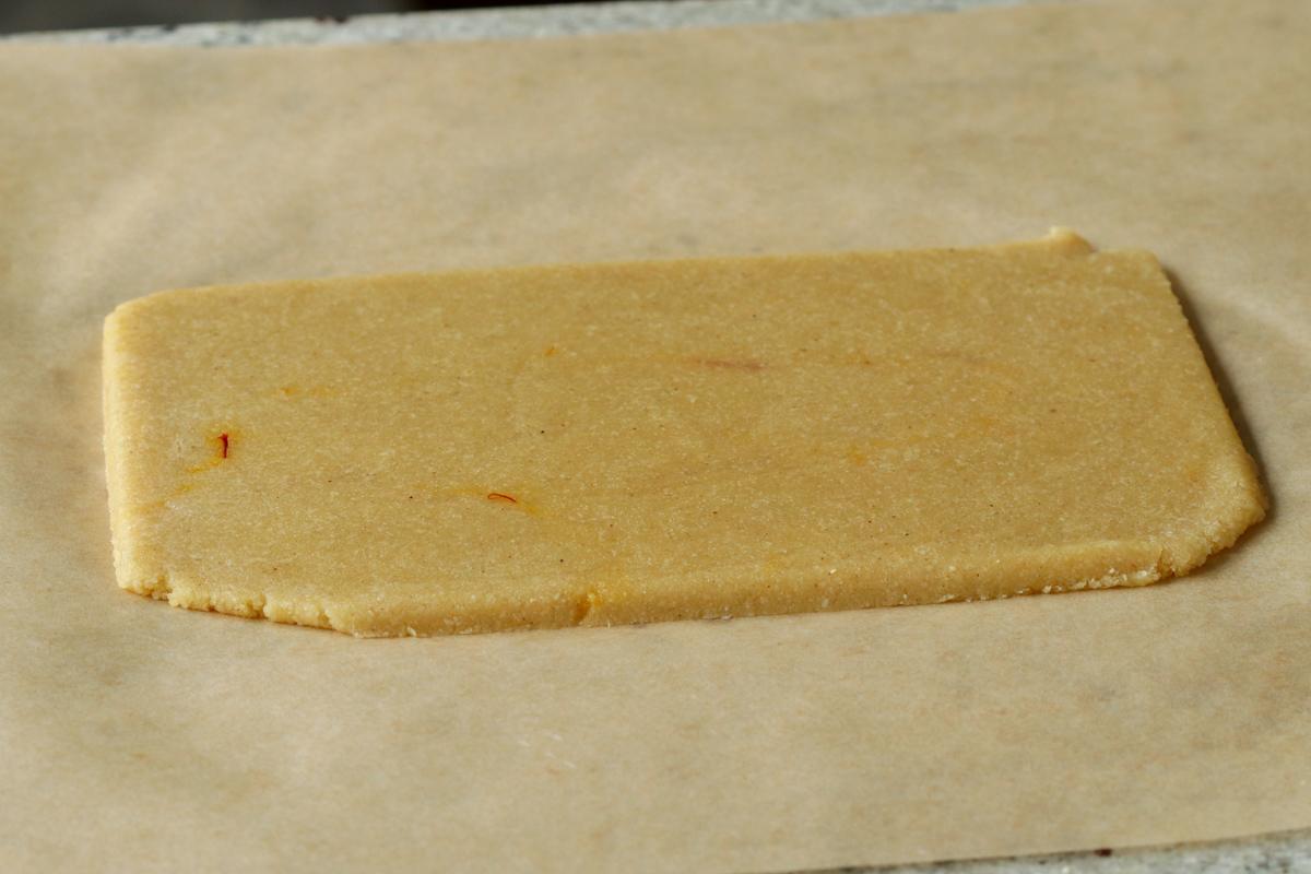 peda dough after rolling out and slicing into a rectangle