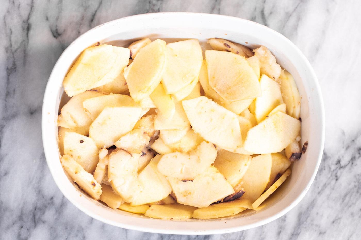 apple slices in a white casserole dish