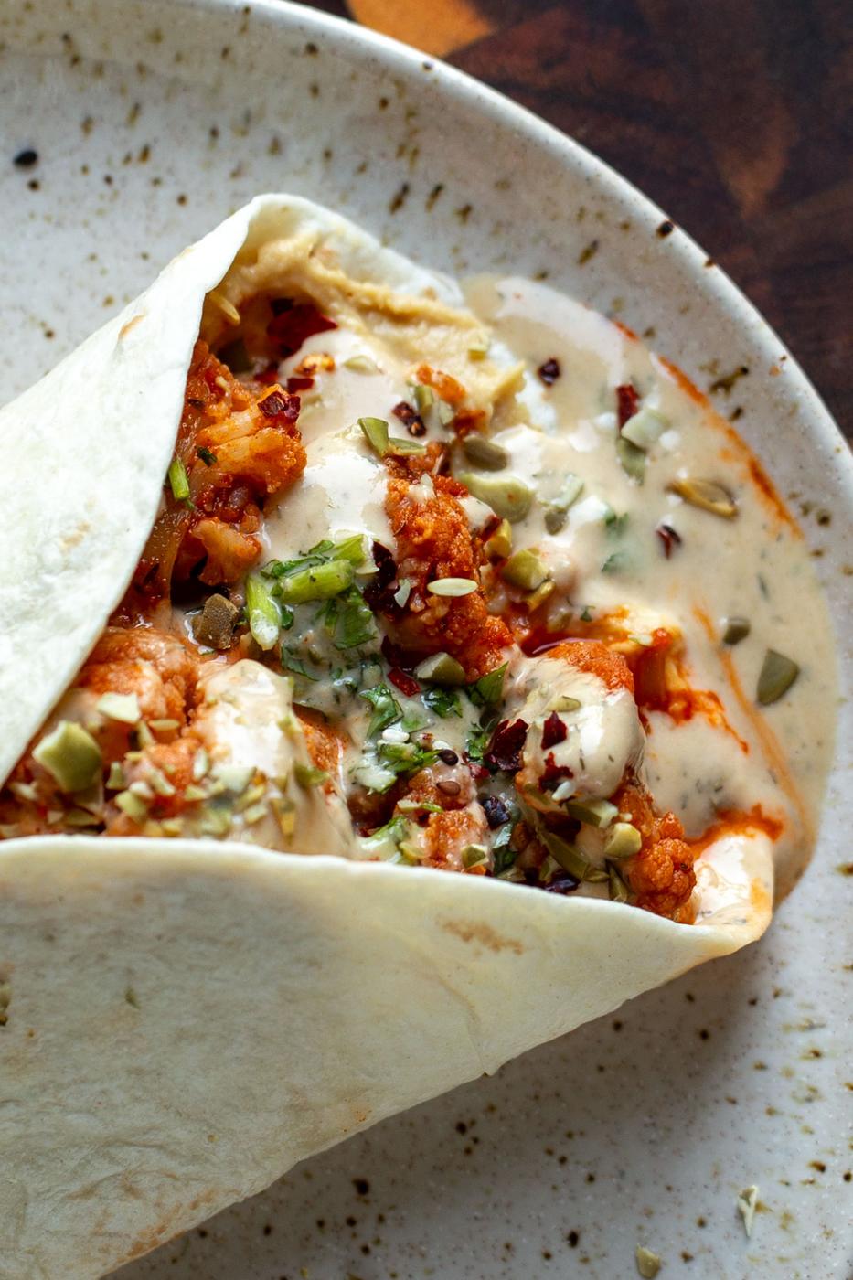 harissa cauliflower wrap with tahini sauce and vegetables