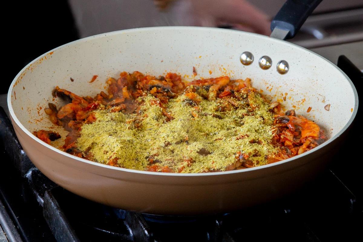 adding nutritional yeast to the pan