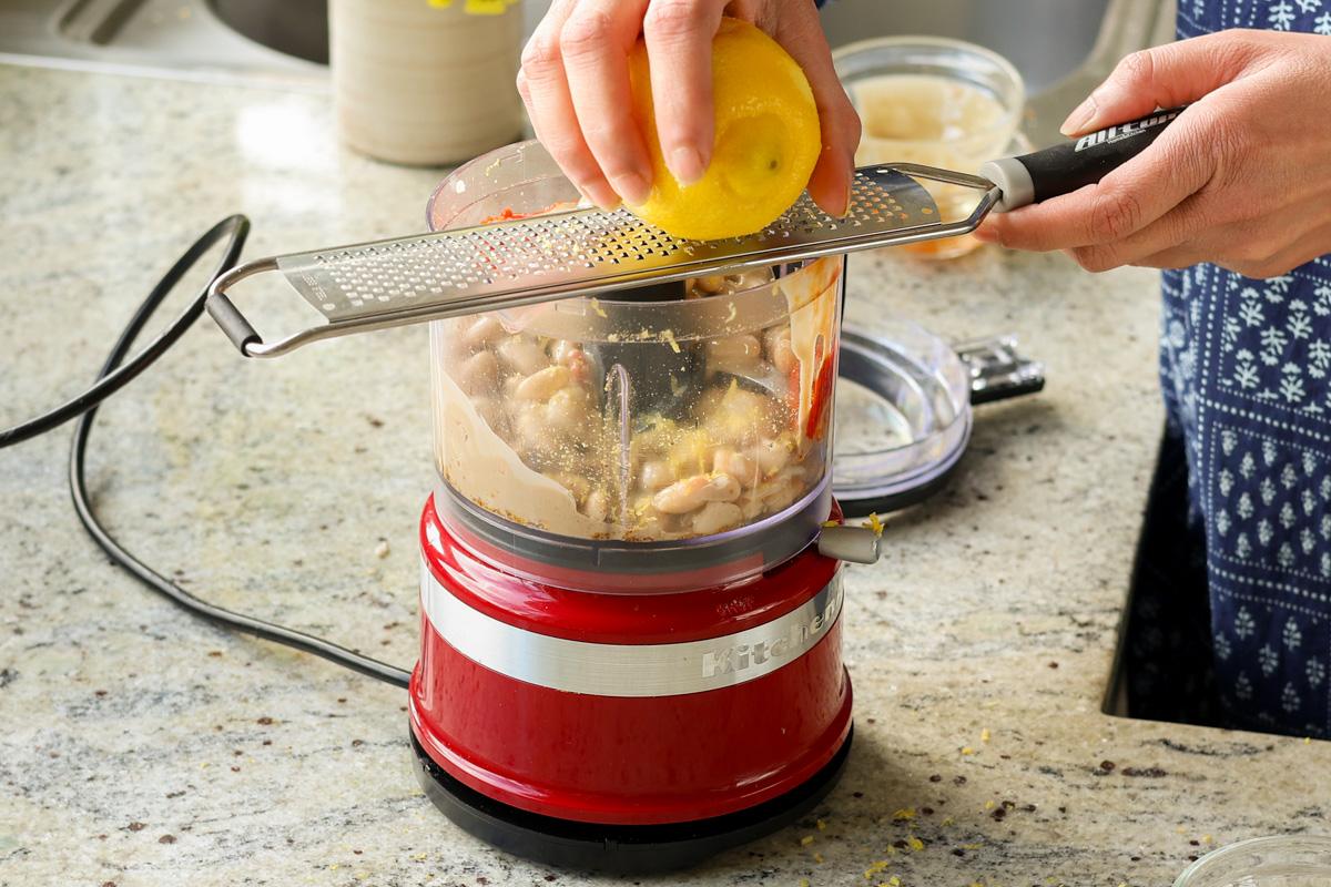 adding lemon zest to the bean mixture