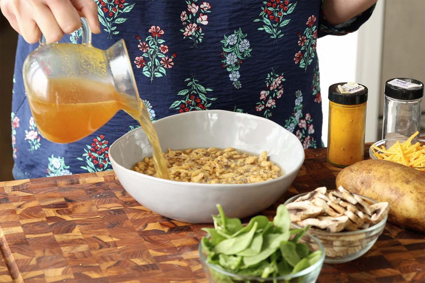adding hot broth to the soy curls