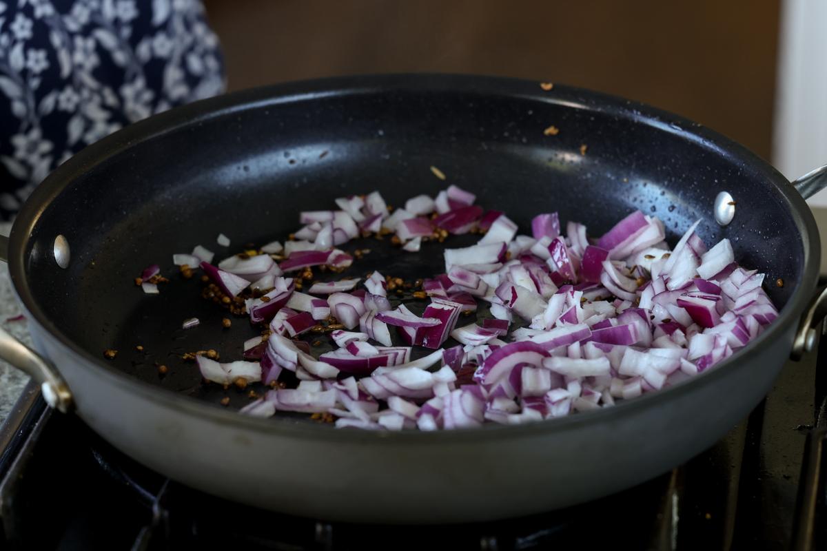 adding onion to the pan
