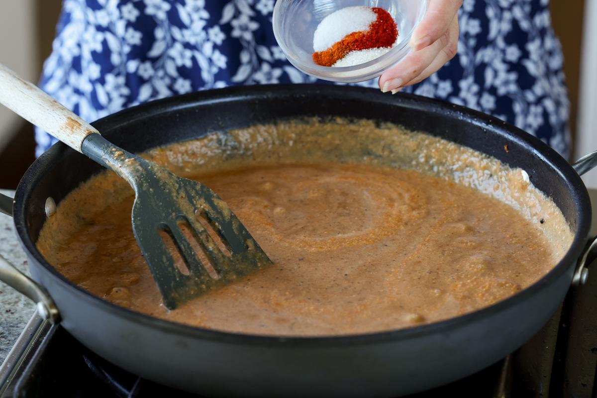 adding salt and ground spices to the Pasanda sauce