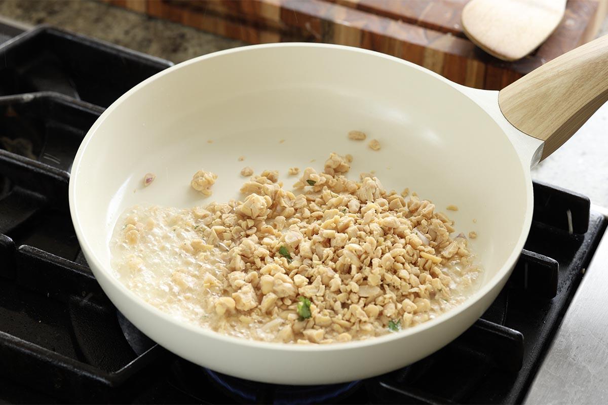 adding crumbled tempeh to the pan