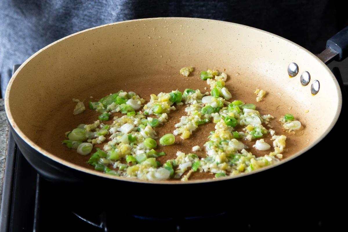 ginger, garlic, and spring onion in the pan, before cooking