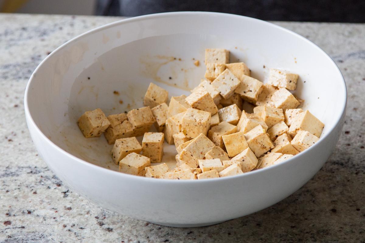 tofu in the bowl with soy sauce, after tossing