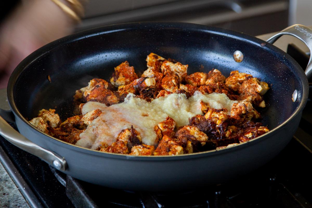 adding ginger-garlic paste to the pan