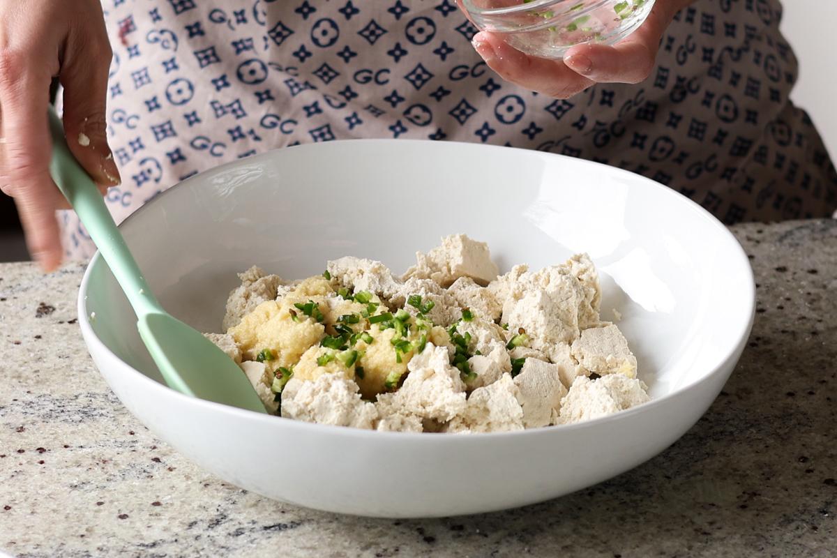 adding tofu, chili, and ginger garlic paste to a separate bowl