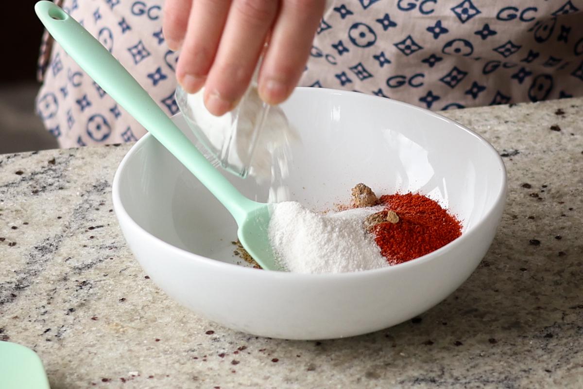 adding cornstarch and spices to the mixing bowl